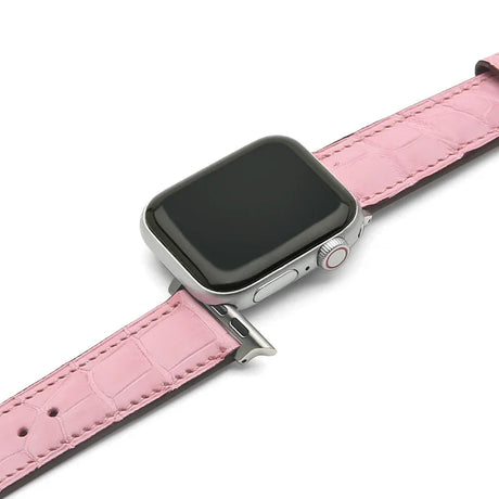 Smartwatch with a pink crocodile skin leather strap on a white background