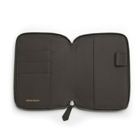Grey leather passport wallet with zipper on a white background