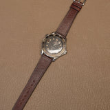 Complete brown Italian Badalassi veg-tan leather watch strap mounted on luxury sports watch on leather desk pad