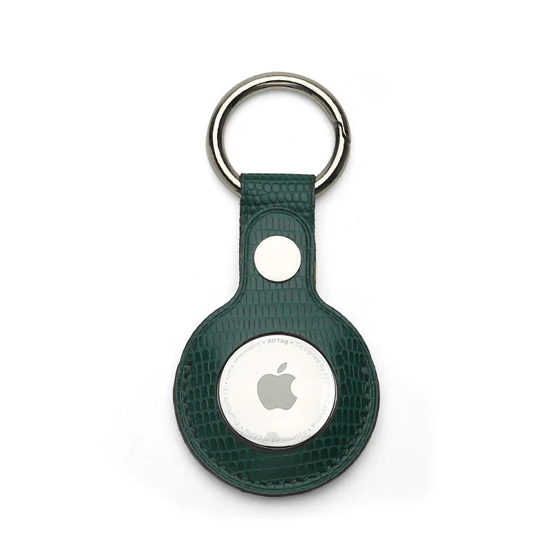 Green Leather Apple AirTag holder with silver ring on a white background