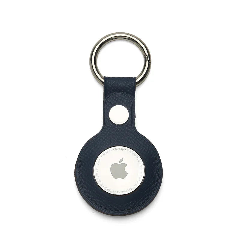 Navy epsom leather Apple AirTag holder on a white background