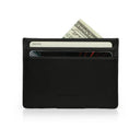 Black vegetable tanned leather card case with money and cards on a white background