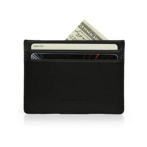 Black vegetable tanned leather card case with money and cards on a white background