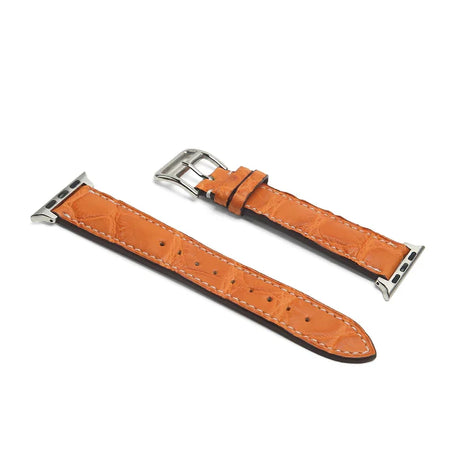 Orange leather watch strap with silver buckle on a white background