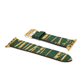Green and gold lizard skin watch strap on a white background