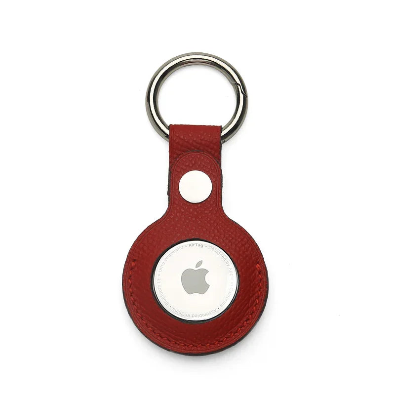 Red epsom leather airtag cover on a white background