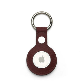 Burgundy leather airtage keychain with Apple logo on a white background