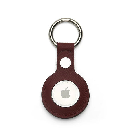 Burgundy leather airtage keychain with Apple logo on a white background