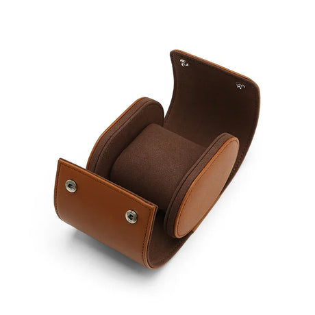 Brown leather watch storage case with a brown interior on a white background