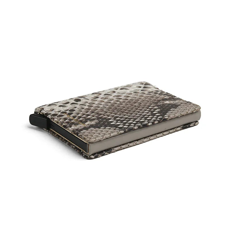 close-up of the edge of the python skin pop up card holder with a white background
