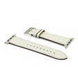 White leather watch strap with silver buckle on a white background