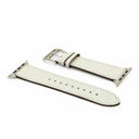White leather watch strap with silver buckle on a white background