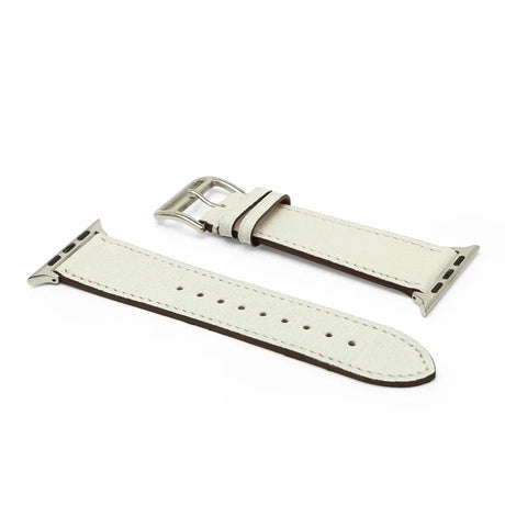 White leather watch strap with silver buckle on a white background