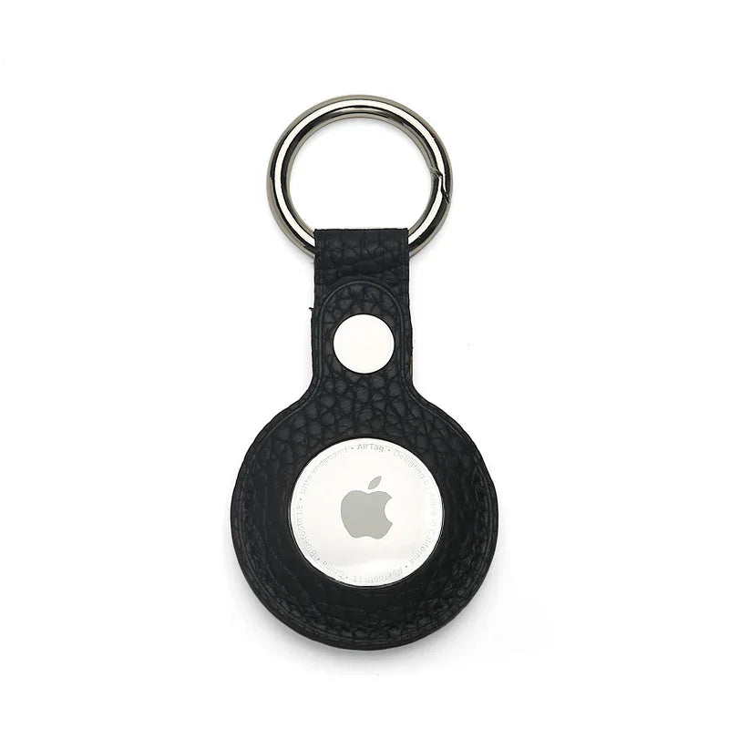 Black pebble leather airtag cover with Apple logo on a white background
