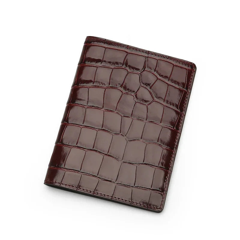 Burgundy crocodile-patterned leather wallet on a white background