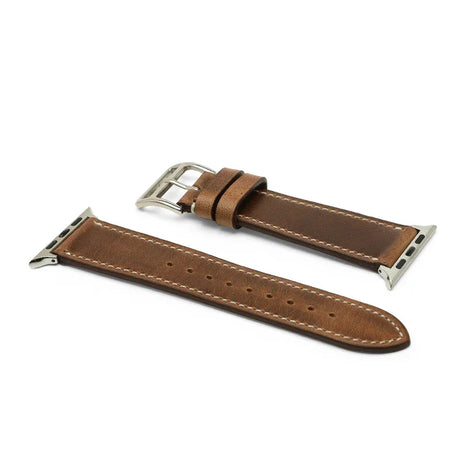 Brown leather watch strap with silver metal clasp on a white background