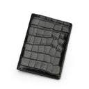 Glossy Black crocodile patterned passport holder on a white background