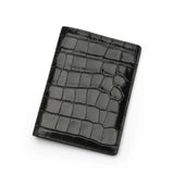 Glossy Black crocodile patterned passport holder on a white background
