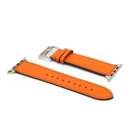 Orange leather watch strap with silver buckle on a white background