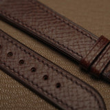 Macro texture of Italian Badalassi embossed veg-tan leather showing precision stitching and sealed edge finish