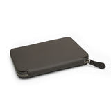 The detail of the edge for the grey leather passport wallet on a white background