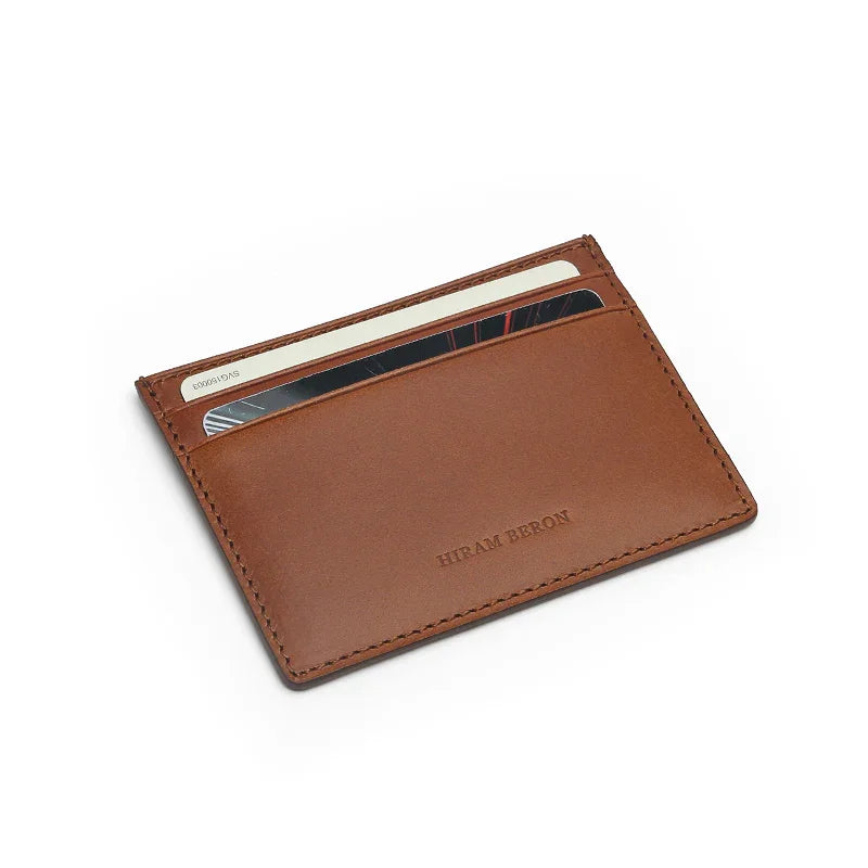 Brown buttero leather cardholder with visible brand name on a white background