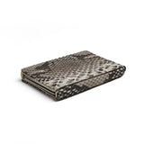 the detail of the edge of the python skin pop up card holder with a white background
