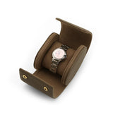 Brown watch storage box with a silver watch on a white background