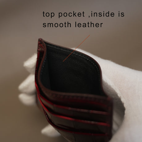 Close-up of a leather card holder with text indicating the top pocket is smooth.