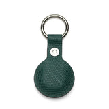 Green leather airtag cover with metallic ring on a white background
