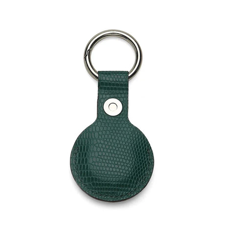 Green leather airtag cover with metallic ring on a white background