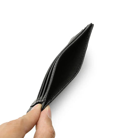 Black leather wallet held open by a hand on a white background