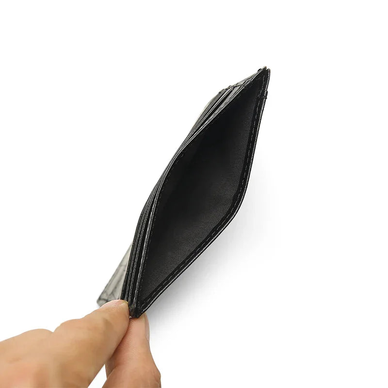 Black wallet held open by a hand on a white background