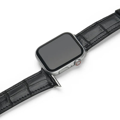 Smartwatch with a black aligator leather watch strap on a white background