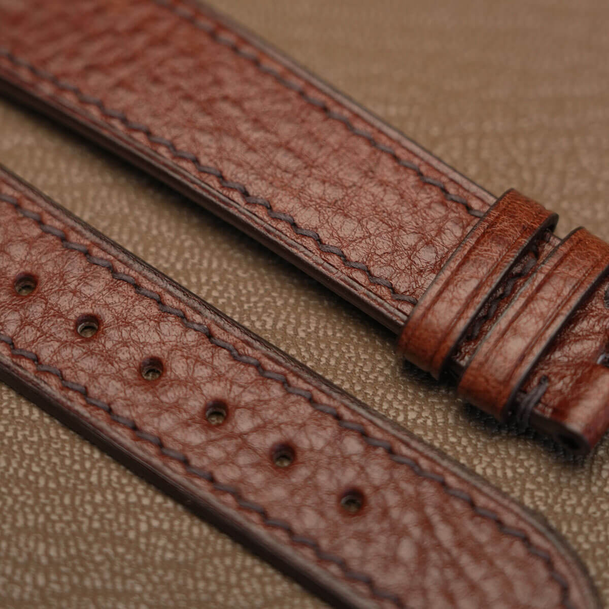 Macro texture of Italian Ausonia double shoulder grain leather watch strap showing clean machine stitch  
