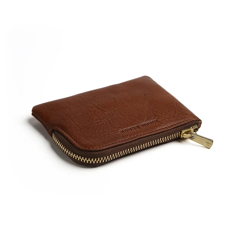 Brown leather coin pouch with a gold zipper on a white background