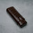 Luxury brown crocodile-textured leather cigar case on concrete surface
