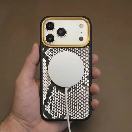 iPhone 17 pro case with snake skin and magsafe charging held by a hand against a brown background