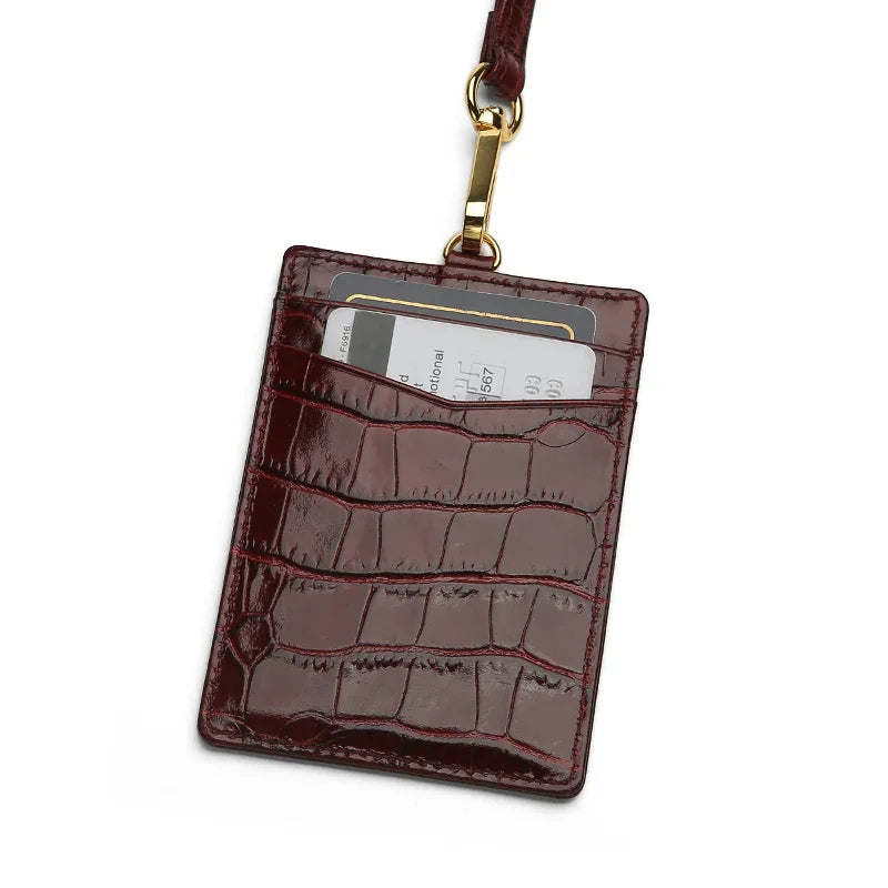 burgundy crocodile pattern ID badge holder with a strap on a white background