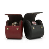 Two watch cases, one red and one black, with watches inside on a white background.