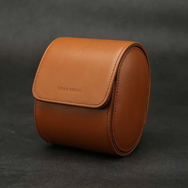 Brown leather watch storage case with 'Hiram Beron' branding on a dark background