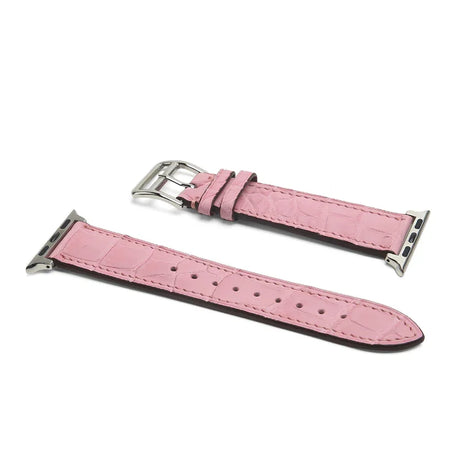 Pink watch strap with silver buckle on a white background