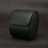 Black saffino leather watch roll on a dark background