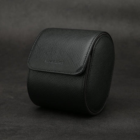 Black saffino leather watch roll on a dark background