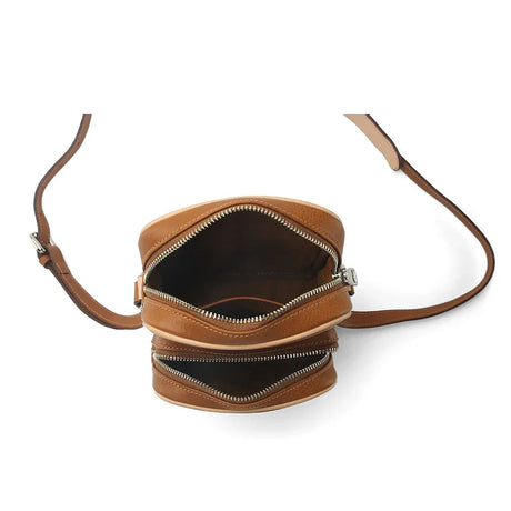Brown leather reporter bag with a visible zipper on a white background