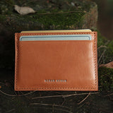 tan vegetbale tanned leather cardholder with card slots on a natural background