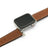 Smartwatch with a brown leather band on a white background