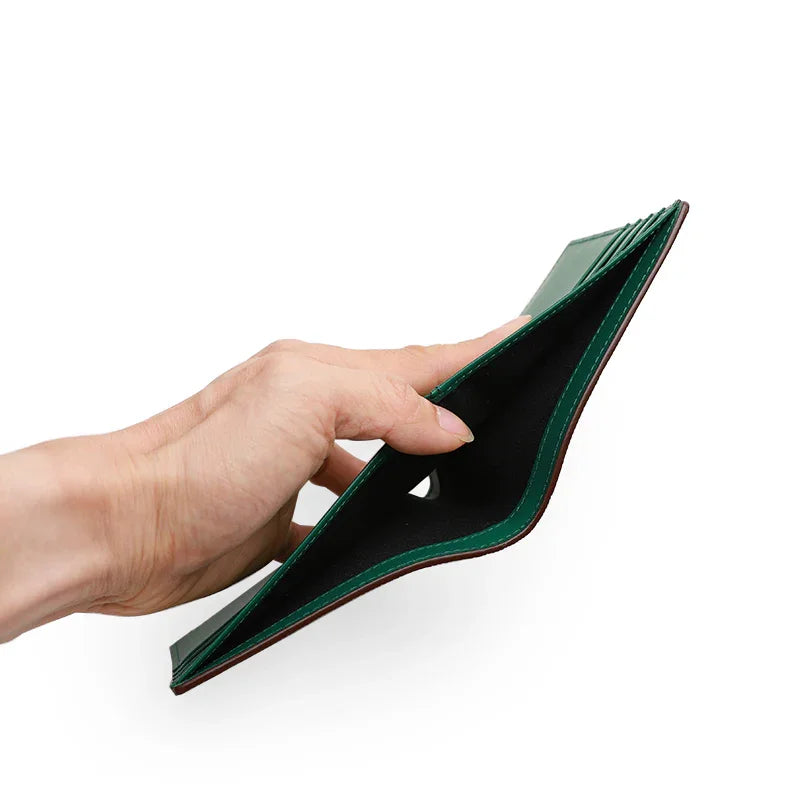 Hand holding an open green wallet against a white background