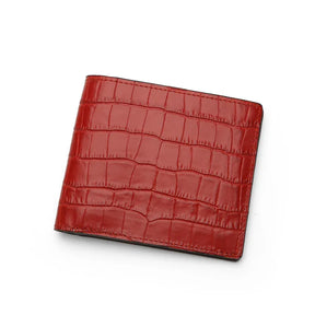 Red aligator-patterned wallet on a white background