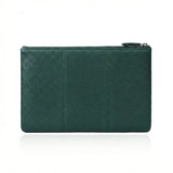 Emerald green pebbled leather clutch with zipper closure, minimalist design for everyday use